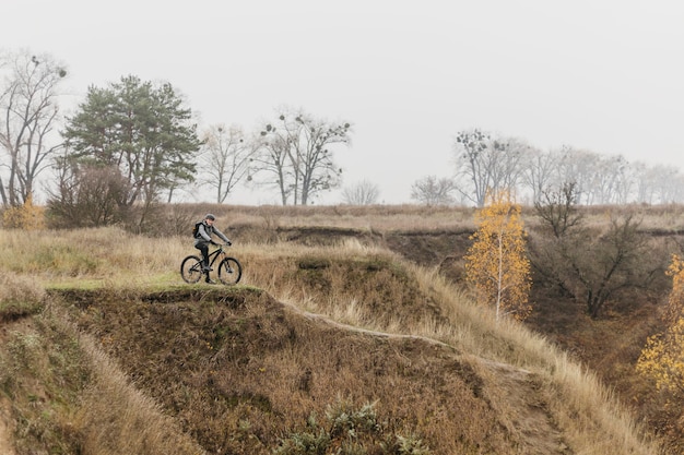 Free Photo man riding a bike on mountain path