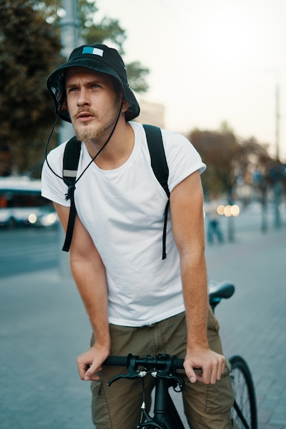 man riding a bike in an old European city outdoors