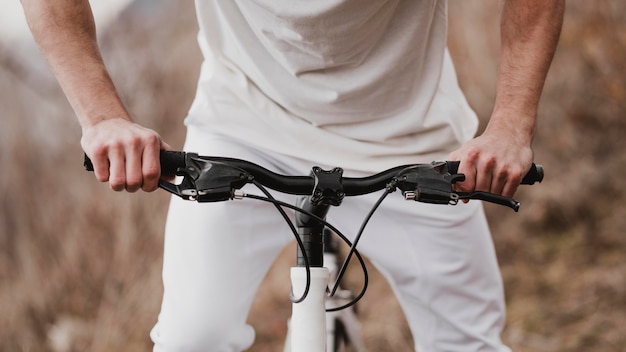 Man riding a bike in white clothes