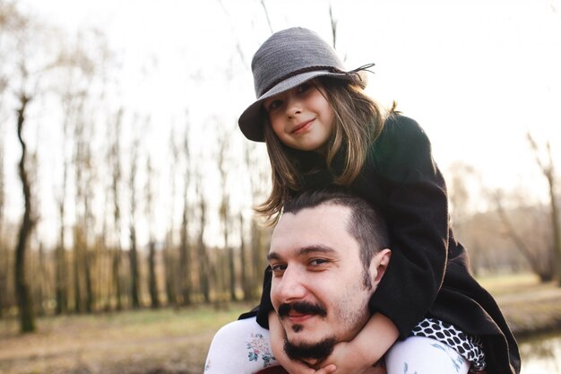 Man riding daughter on shoulders