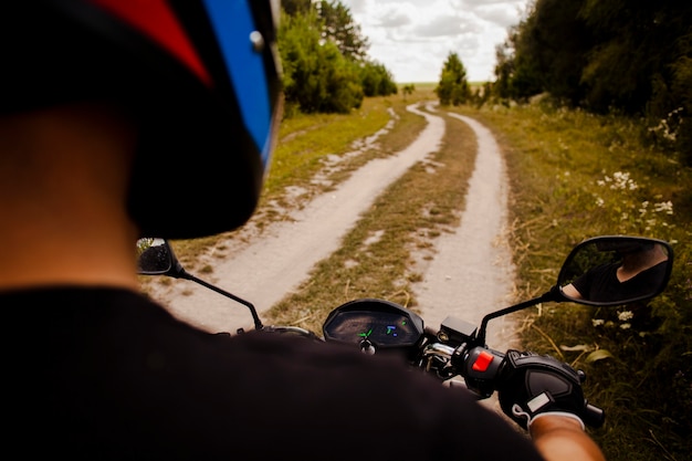 Free photo man riding motorbike on dirt road