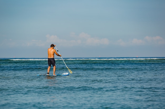 Man riding sup. 