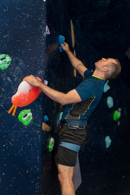 Man rock climbing indoors in the arena