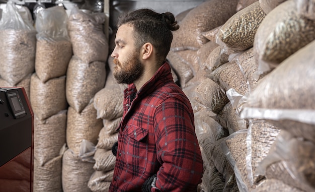 Free photo a man in a room with a solid fuel boiler, working on biofuel, economical heating.