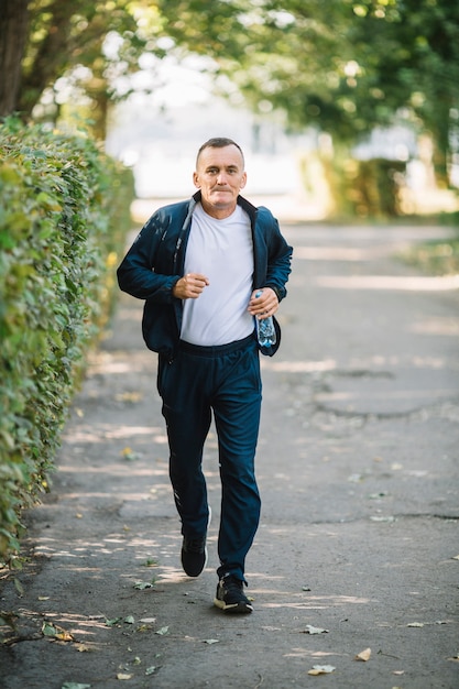 Man running on an alley in park