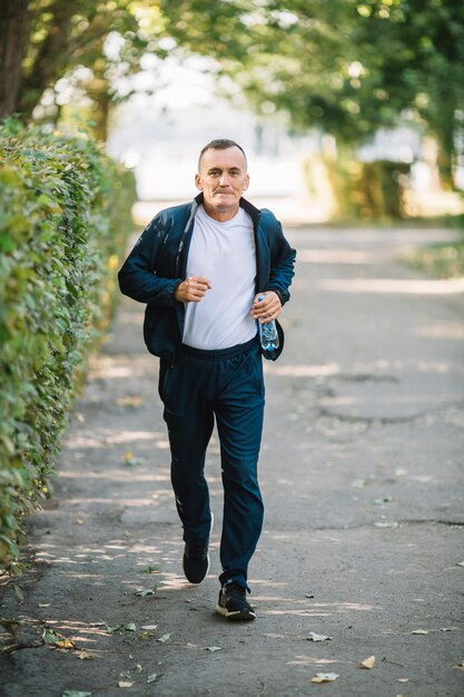 Man running on an alley in park