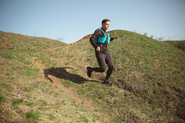 Man running in a park or forest against trees