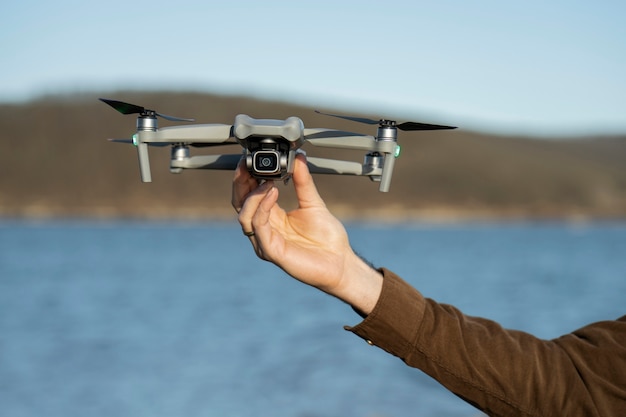 Man's hand holding drone outdoors