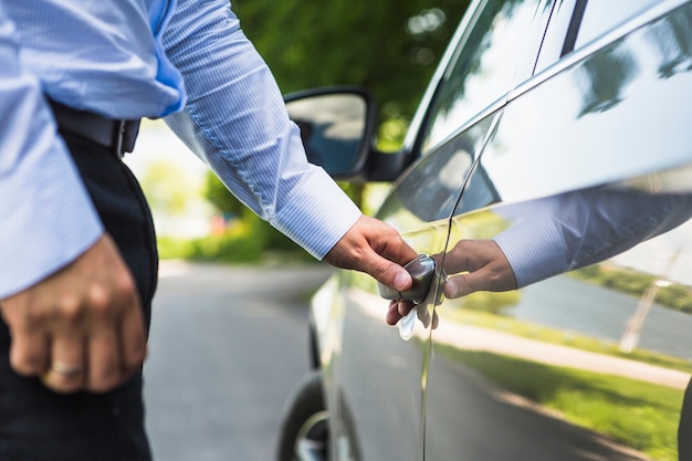 Man's hand opening car door