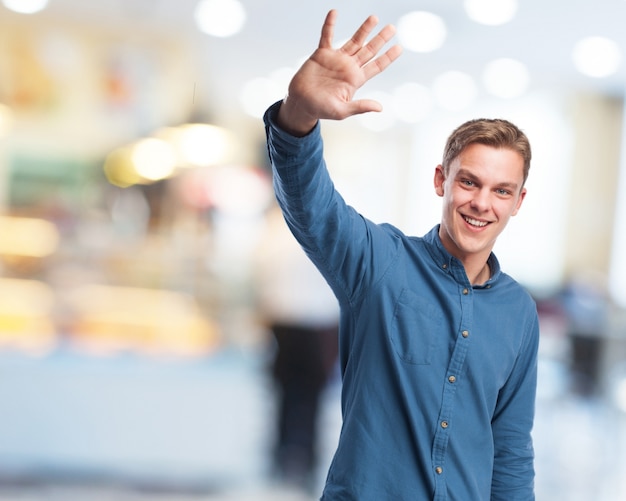 Free photo man saying goodbye with his hand