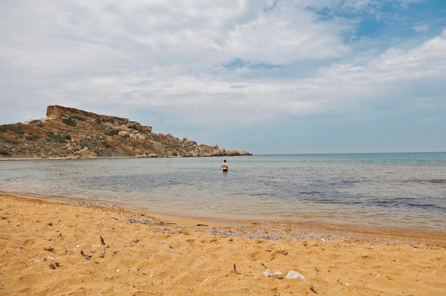 Free photo man in the sea, malta, mellieha