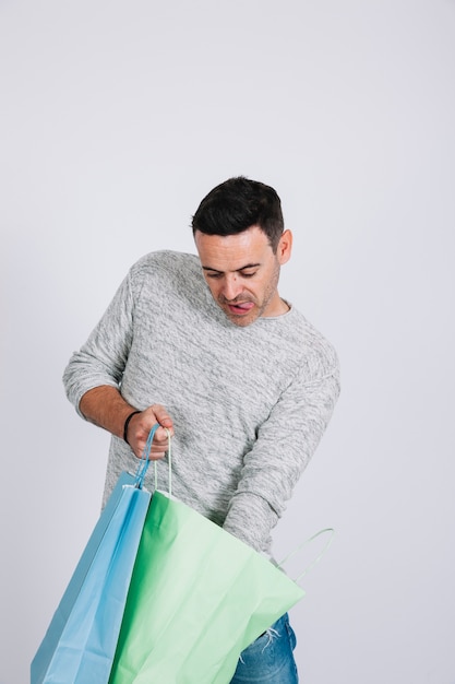 Man searching in shopping bag