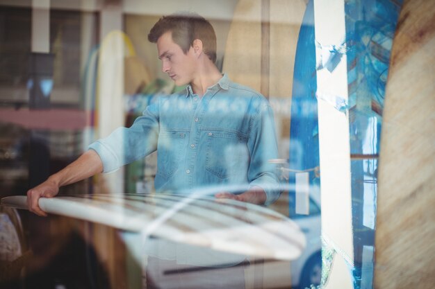 Man selecting surfboard