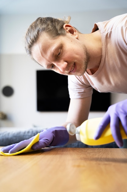 Free photo man servant doing chores around the house