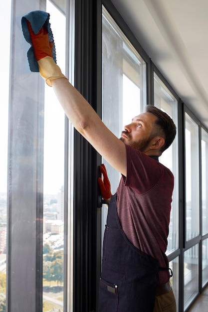 Free Photo man servant washing windows