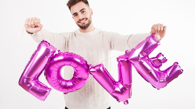 Man showing balloon love writing