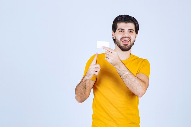 Man showing his business card and presenting himself with a confidence.