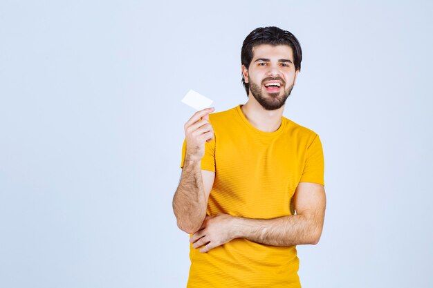 Man showing his business card and presenting himself with a confidence.