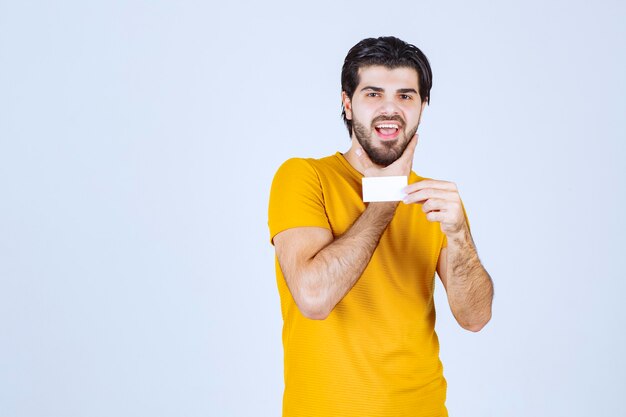 Man showing his business card and presenting himself with a confidence.