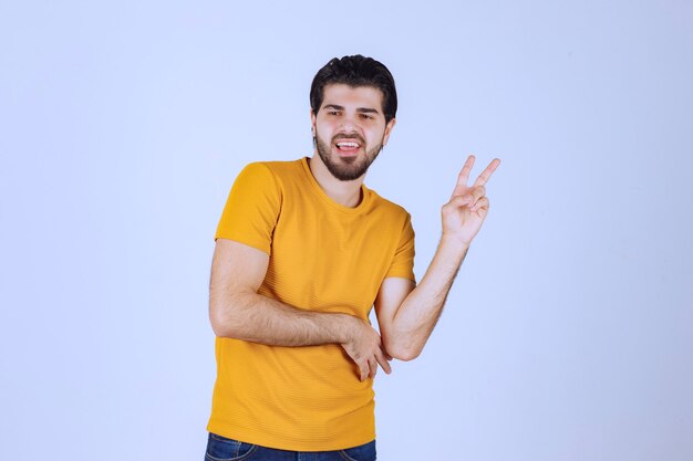 Man showing peace and friendship sign in the hand.