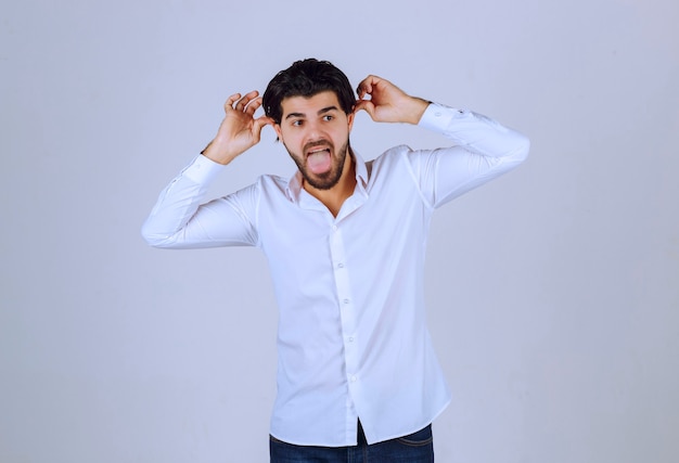 Man showing rabbit or wolf hand sign.