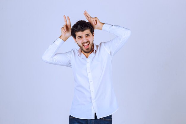 Man showing rabbit or wolf hand sign. 