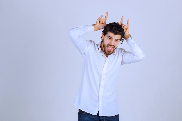 Man showing rabbit or wolf hand sign. 