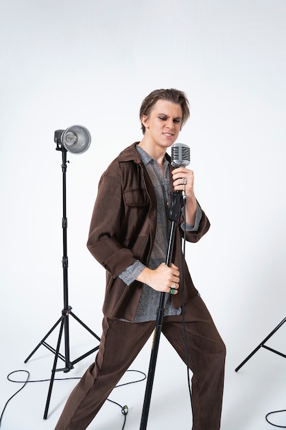 Man singing with microphone full shot