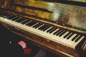 Free photo man sits at an old vintage piano