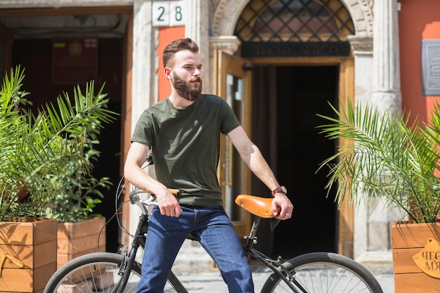 Free photo man sitting on bicycle