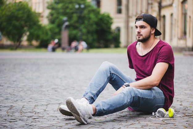 Man sitting on block stone thinking