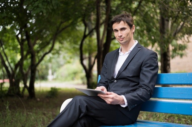 Man sitting on blue bench