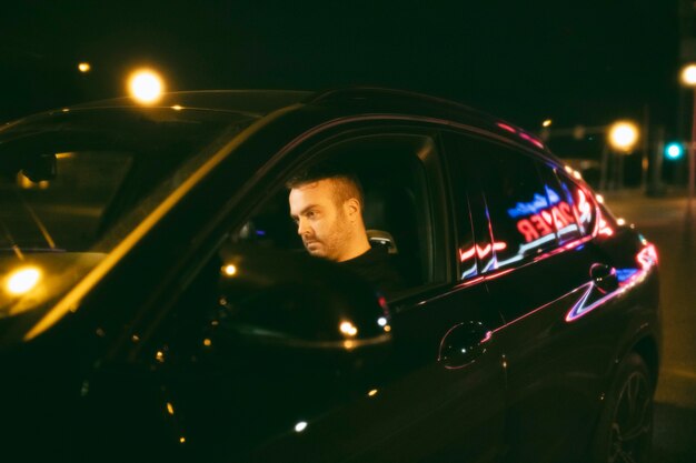 Man sitting in the car at night