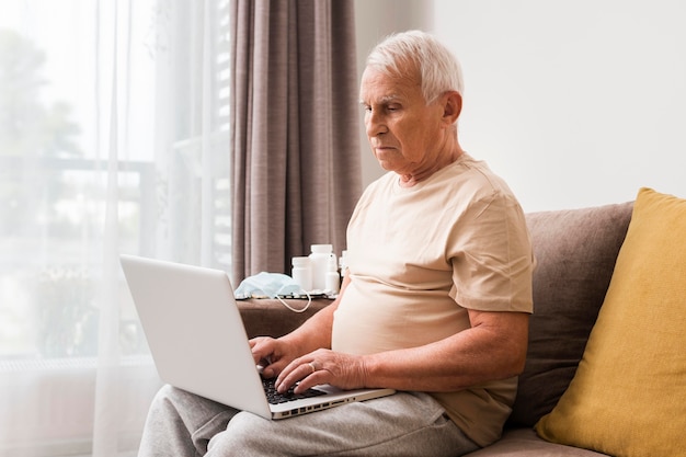 Man sitting on couch with laptop