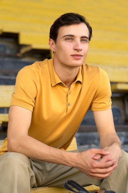 Man sitting in grandstands medium shot