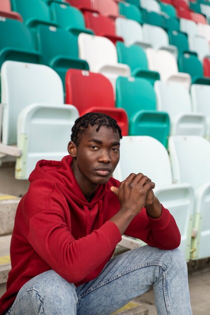 Man sitting on grandstands medium shot