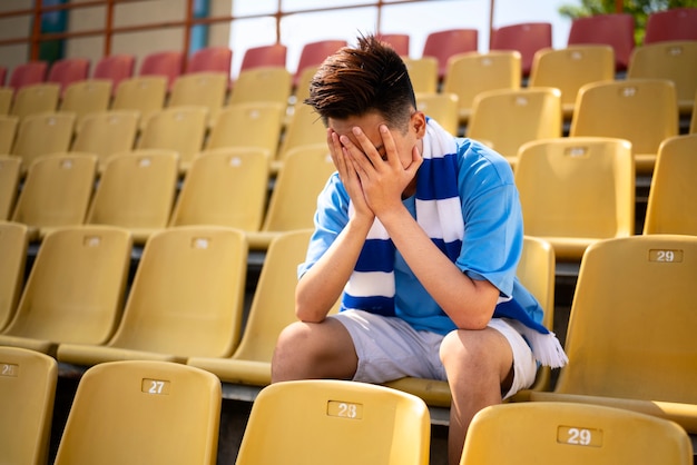 Free Photo man sitting on grandstands side view