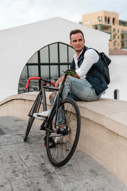 Man sitting next to his bike