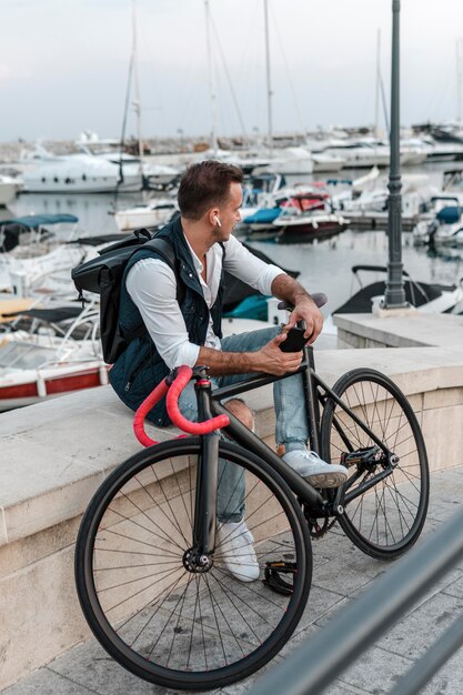 Man sitting and looking away next to his bike