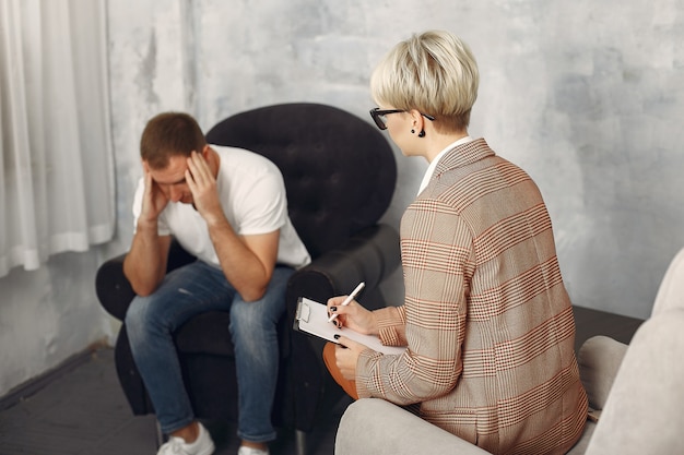 Man sitting in the psychologist's office and talking about problems