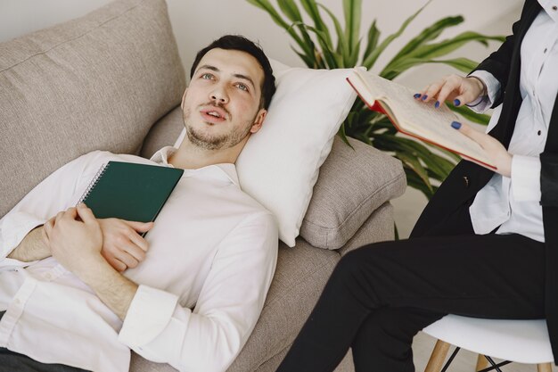 Man sitting in the psychologist's office and talking about problems