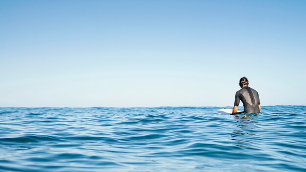 Man sitting in the water copy space