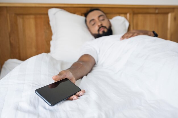 Man sleeping after spending time on his phone