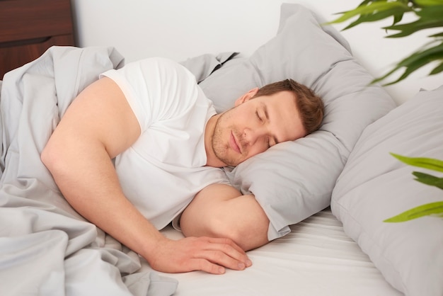 Man sleeping in the comfortable bed
