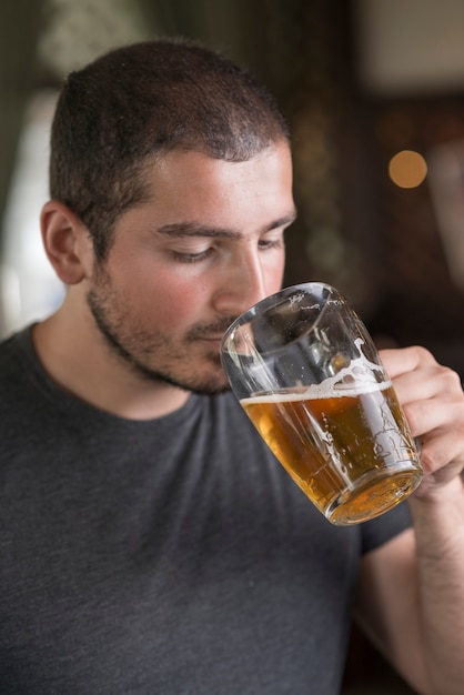 Man smelling beer in bar