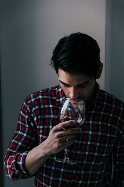 Free Photo man smelling on wine