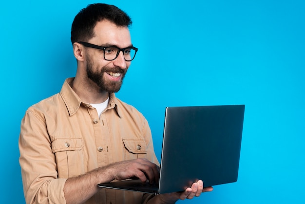 Man smiling while looking at laptop