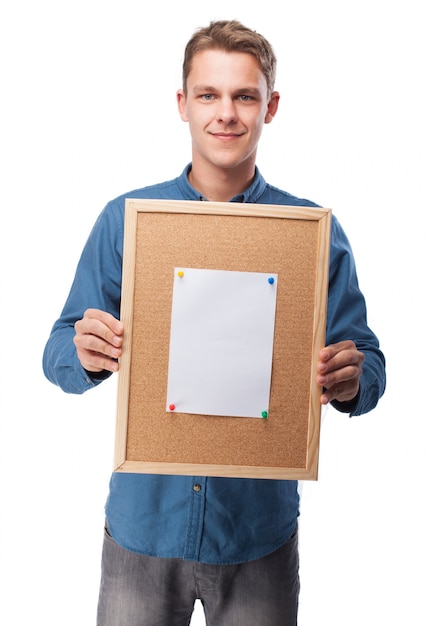 Free photo man smiling with a blank paper on a board