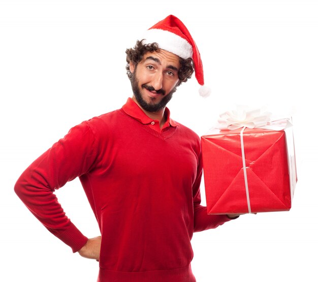 Man smiling with santa's hat and a gift