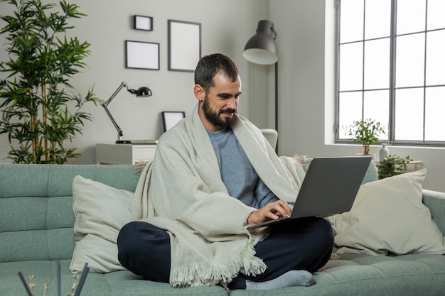 Man on sofa working on laptop